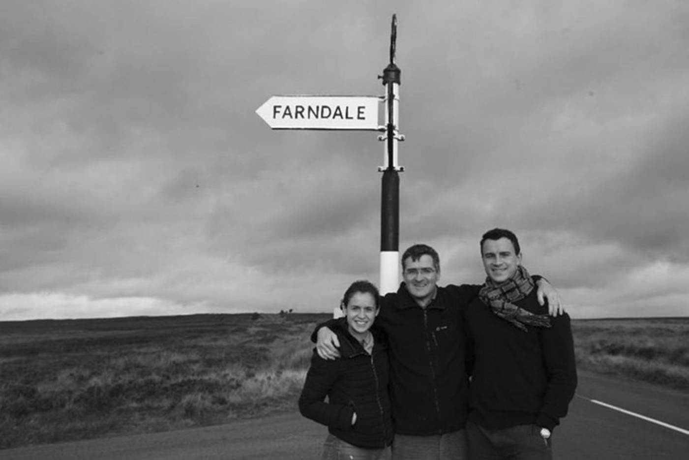 A group of people standing in front of a sign
AI-generated content may be incorrect.
